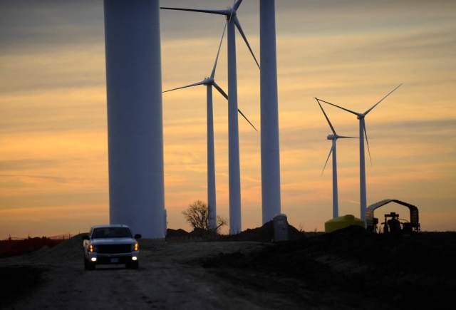Wind turbines, built to provide eco-friendly power, stand at sunset in Greensburg, Kansas.