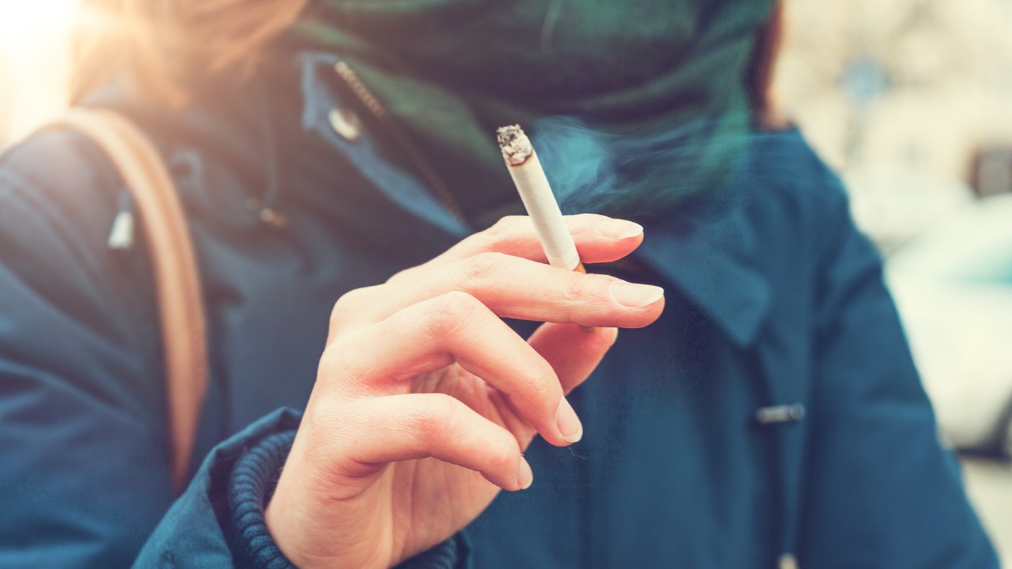 Young woman enjoying a cigarette; Zealand's new cigarette ban