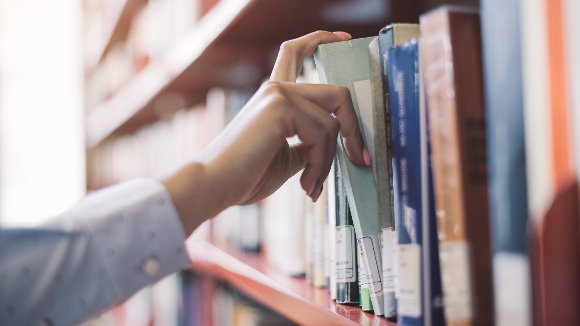 Student searching books at a local library