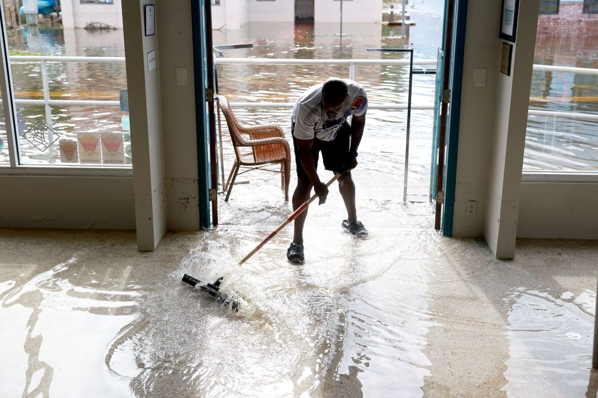 A person pushes water after flooding from Hurricane Idalia.