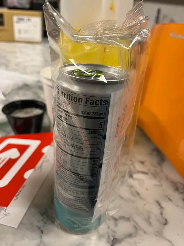 plastic-wrapped can