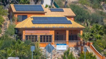 A house with multiple rooftop solar panels.