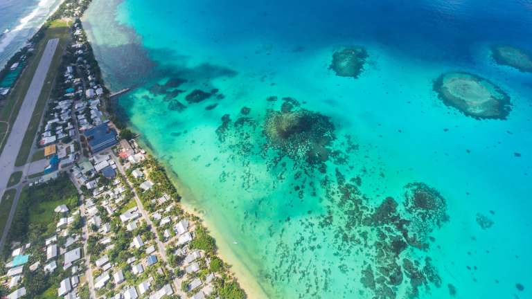 The island country of Tuvalu is located about halfway between Australia and Hawai'i in the west-central Pacific Ocean.