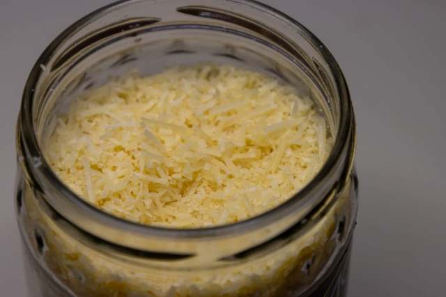 Don't throw out your empty Parmesan cheese containers right away, because TikTok user Megan found the perfect way to reuse the lids.