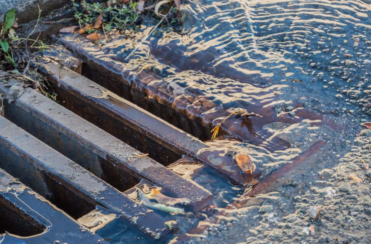 Two men were arrested in Miami after being caught dumping cooking grease into a storm drain.