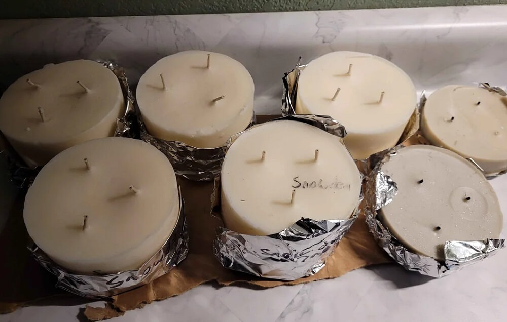 A Redditor shared photos of their largest dumpster diving haul yet, with dozens of packaged food items and recalled candles rescued from the trash.