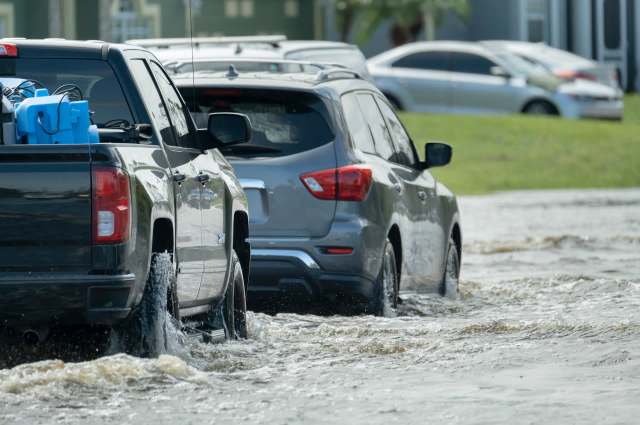 A shark swimming through a flooded parking lot in Boynton Beach, Florida, is an alarming display of the area's severe flooding problem.