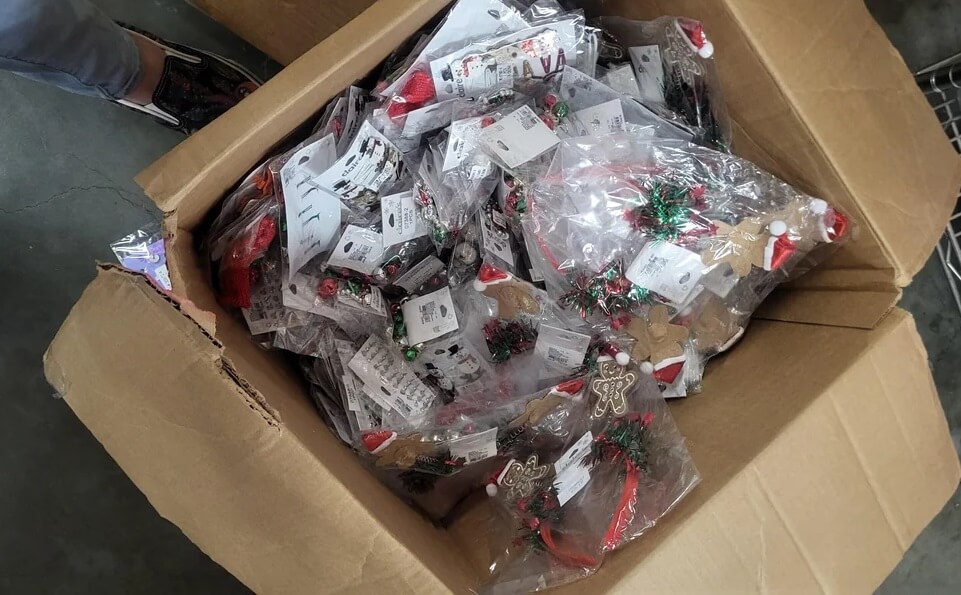 A frustrated Redditor shared a photo of a box filled with Christmas decorations and Claire's accessories wrapped in a lot of plastic.