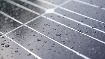 MIT researchers developed a lightweight polymer coating for solar panels, known as 2DPA-1, to limit the corrosive damage that gas particles can inflict.