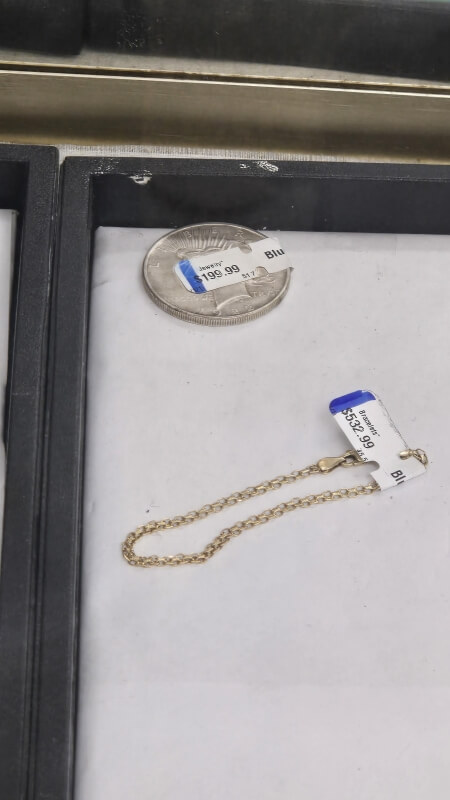 Thrift shoppers were shocked to discover inflated price tags on an American Peace dollar coin and a vintage gold bracelet.