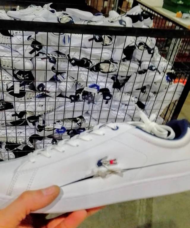 A Redditor shared a photo on r/LateStageCapitalism featuring a dumpster overflowing with Lacoste shoes.