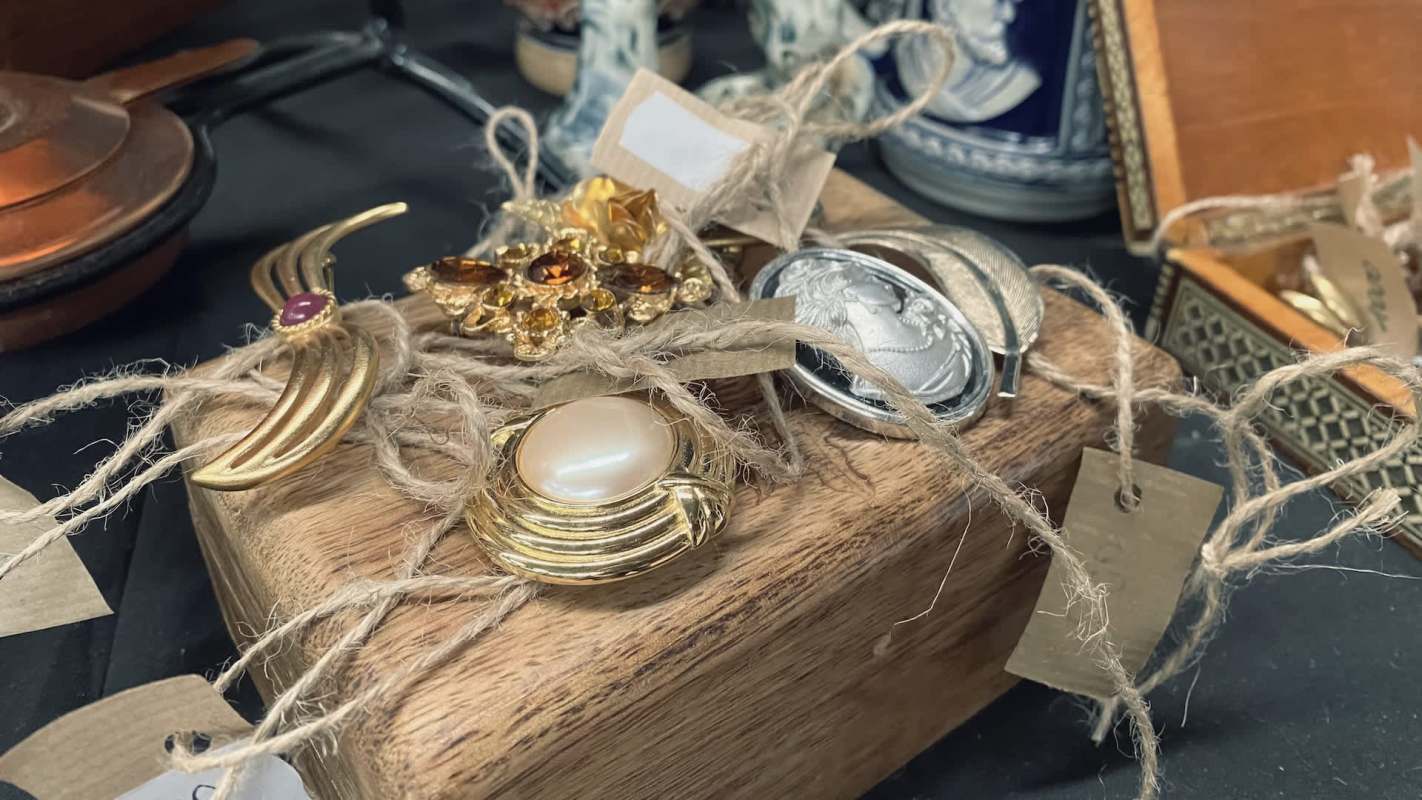 Thrift shoppers were shocked to discover inflated price tags on an American Peace dollar coin and a vintage gold bracelet.