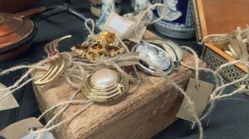 Thrift shoppers were shocked to discover inflated price tags on an American Peace dollar coin and a vintage gold bracelet.