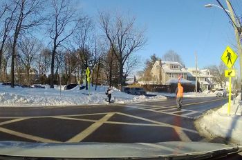 Crossing guards help ensure pedestrian safety by controlling traffic and providing visible protection against distracted and speeding drivers.