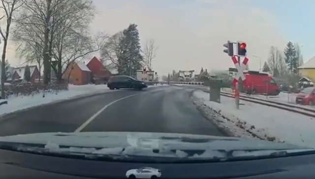 A Reddit user uploaded dashcam footage of reckless driving in Germany, showing a car attempting to cross a train track while the crossing gates are lowered.