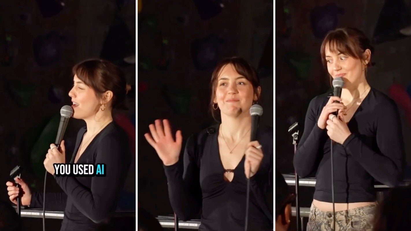 A woman stands on stage with a microphone, smiling and engaging with the audience during a performance.