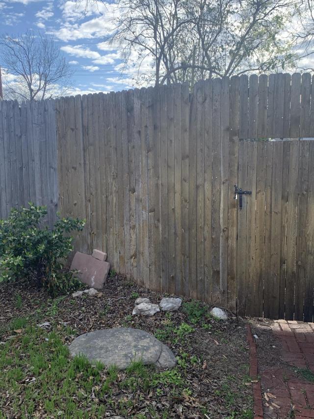 The fence after the OP's neighbor cut down trees and removed the flowers.