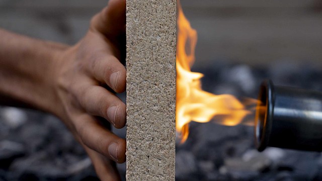 Person testing fire-resistant building material.