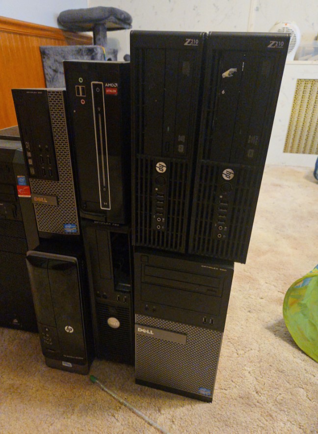 A more full view of the computer towers on a carpeted floor.