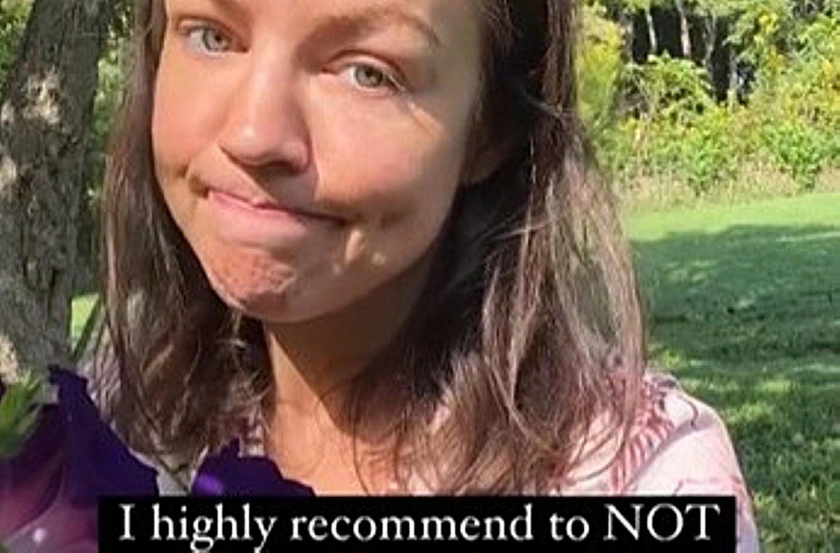 A woman with long hair makes a playful facial expression while suggesting not to do something.