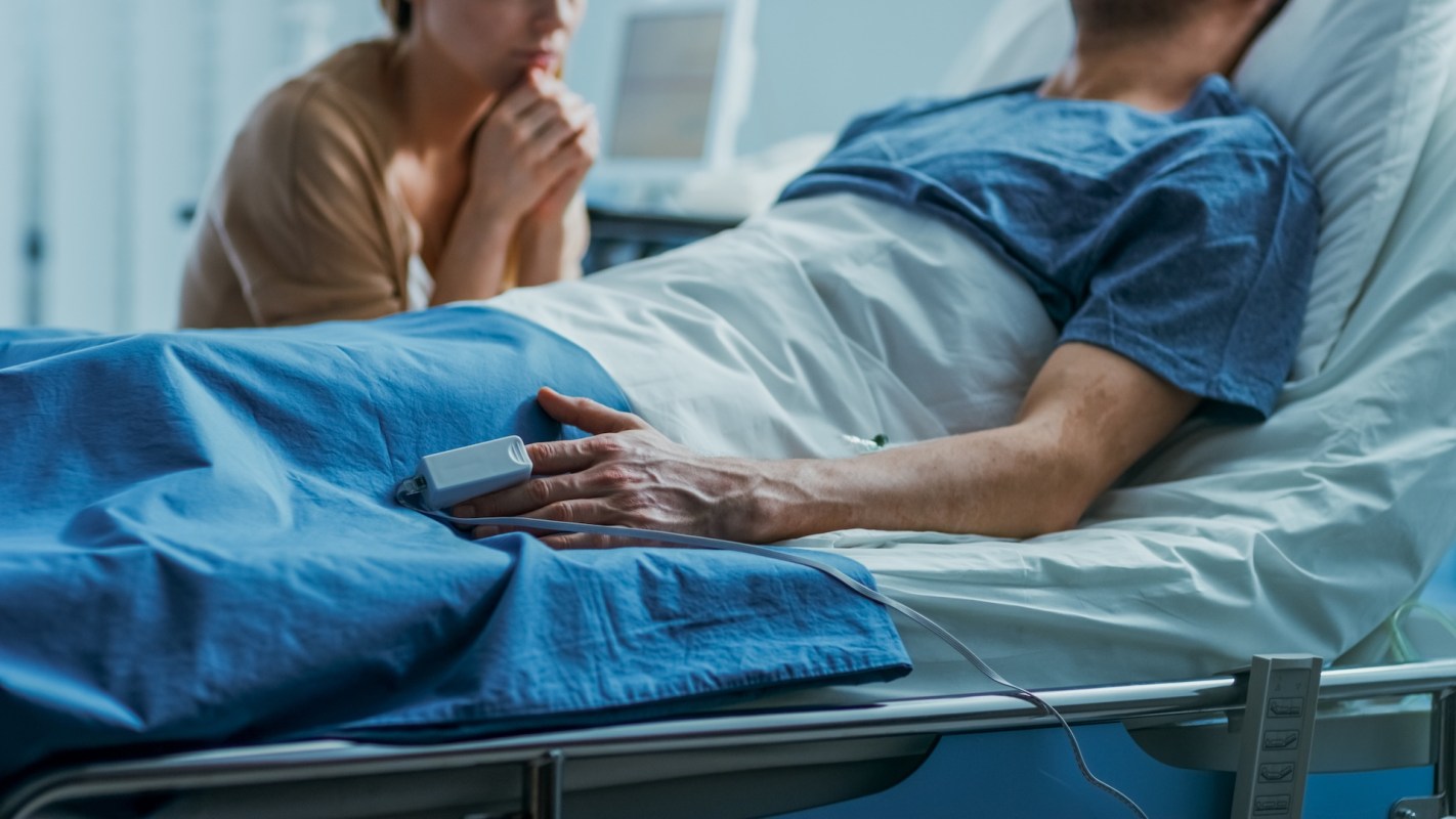 A patient recovering from a tick bite in a hospital with a visitor.