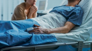 A patient recovering from a tick bite in a hospital with a visitor.