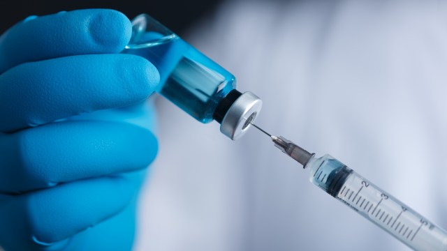 Medical professional preparing a vaccine shot.