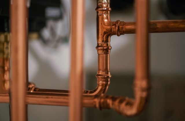 Copper pipes attached to heat pump water heater.
