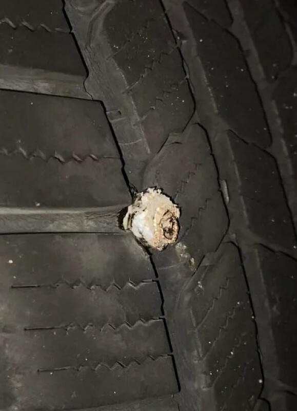 A car tire with a hole in it. 