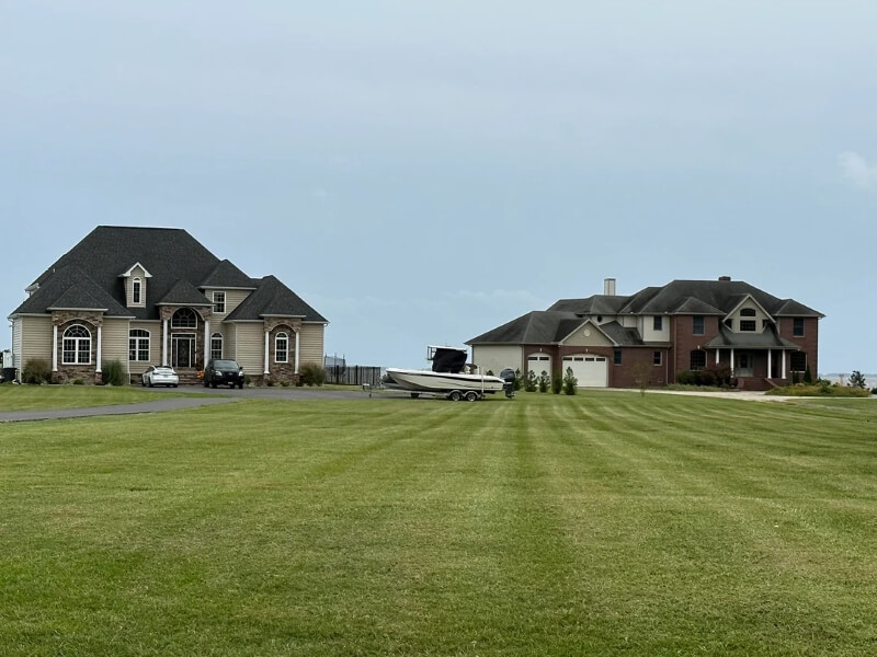 A contributor in the r/McMansionHell subreddit was frustrated to spot, not one, but two large houses surrounded by unattractive lawns in an area that they otherwise love.