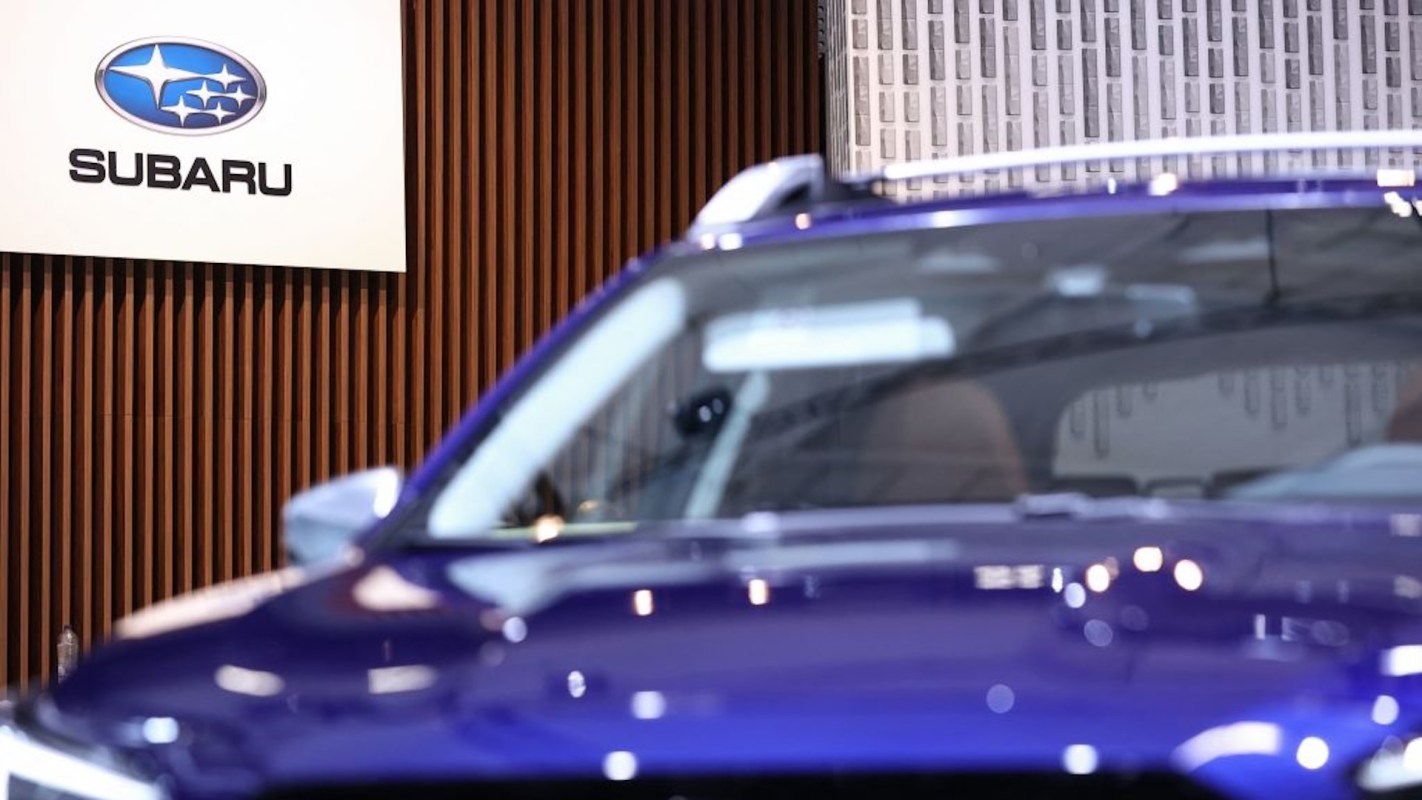 A close-up of a purple Subaru vehicle with the brand logo in the background.