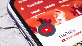 A close-up of a smartphone screen displaying the YouTube app interface with a colorful background.