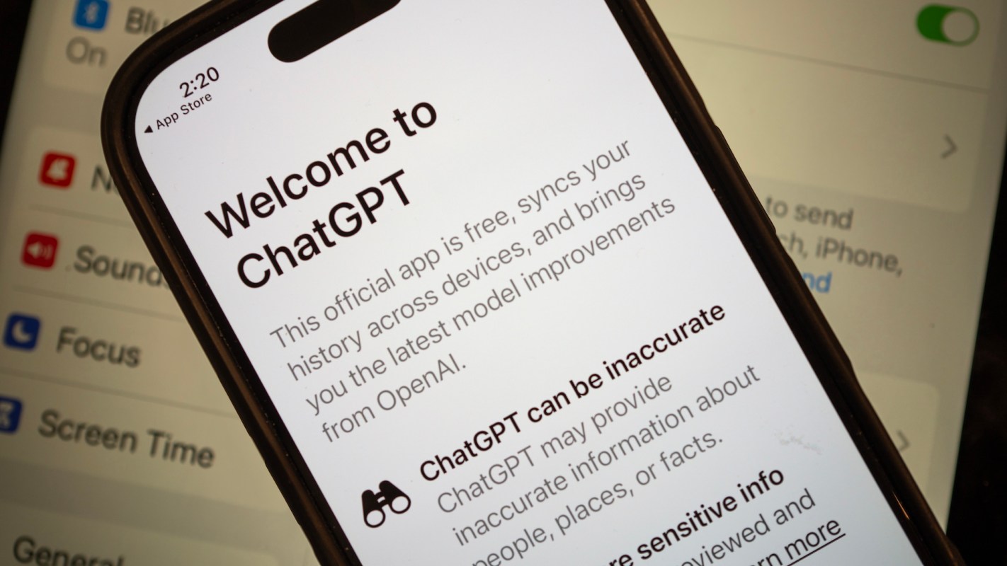 A smartphone displaying the welcome screen for the ChatGPT app with settings in the background.
