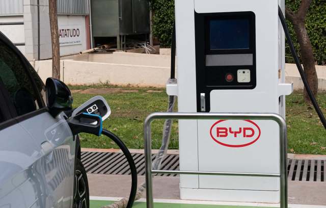 A BYD electric vehicle charging station charging a car.