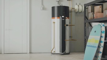 A modern Cala heat pump water heater sits in a garage.