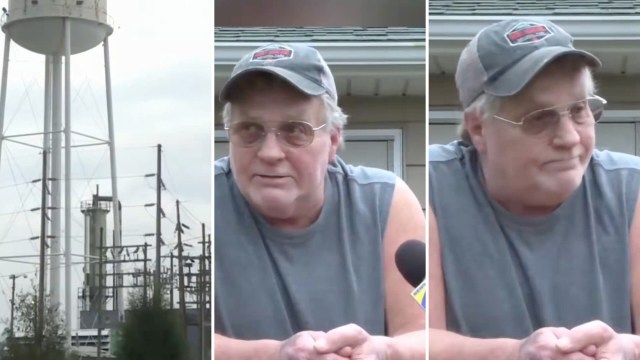 A man in a sleeveless shirt speaks in front of a water tower and power lines by a data center.