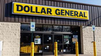 A Dollar General storefront with a large yellow sign and reserved parking signs in front.