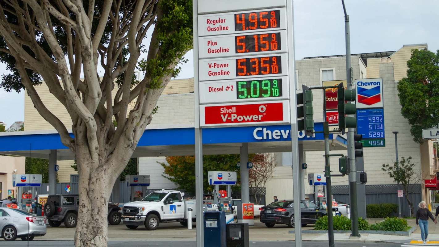 A gas station displaying fuel prices for regular, plus, V-Power gasoline, and diesel.