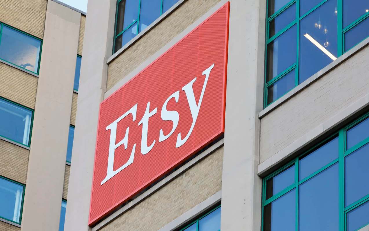 A close-up of the Etsy logo on a building's exterior, showcasing the brand's distinctive red background.
