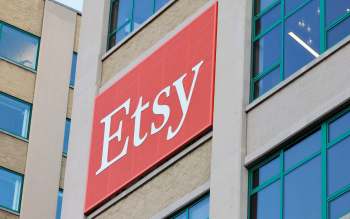 A close-up of the Etsy logo on a building's exterior, showcasing the brand's distinctive red background.