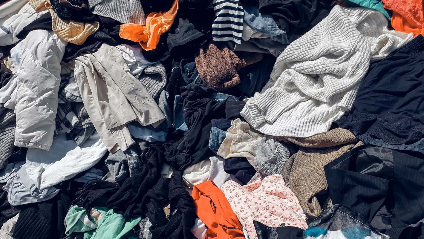 A colorful assortment of various clothing items piled together on a flat surface.