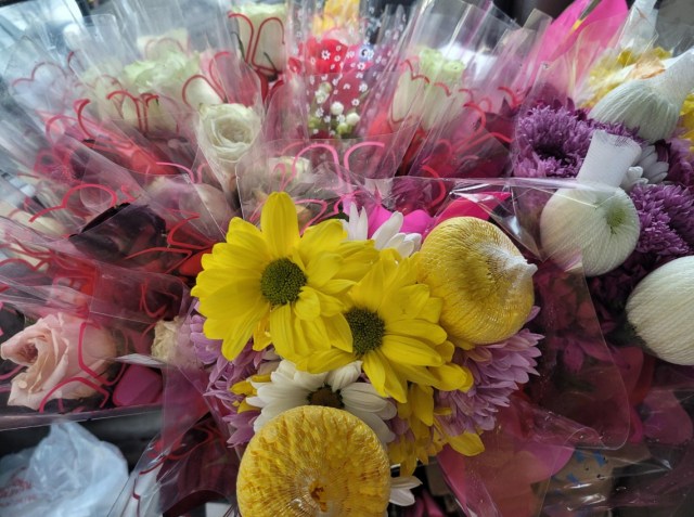 Bright bouquets of assorted pink, white, red, purple, and yellow flowers. 