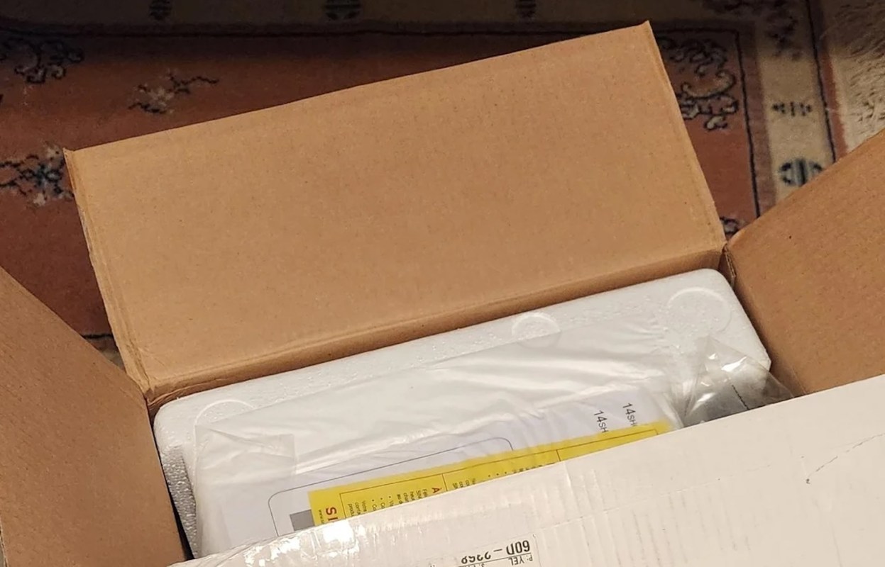 A sewing machine from a thrift store in a box.