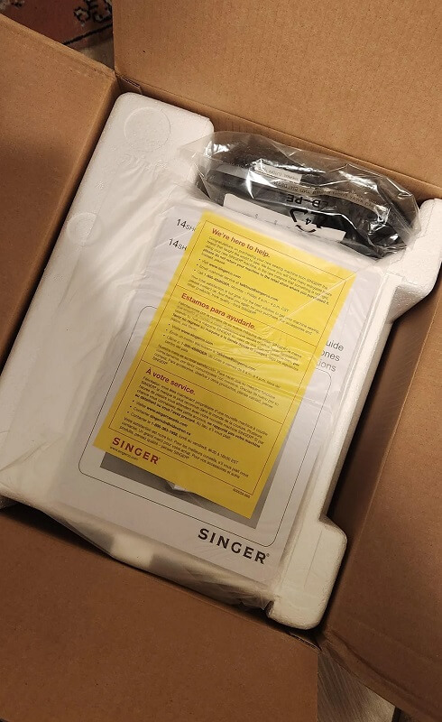 The inside of a Singer Serger sewing machine box.