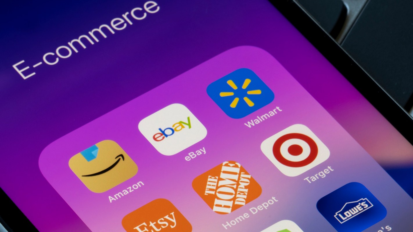 An e-commerce app folder on a smartphone screen displays icons for Amazon, eBay, Walmart, Target, and others.