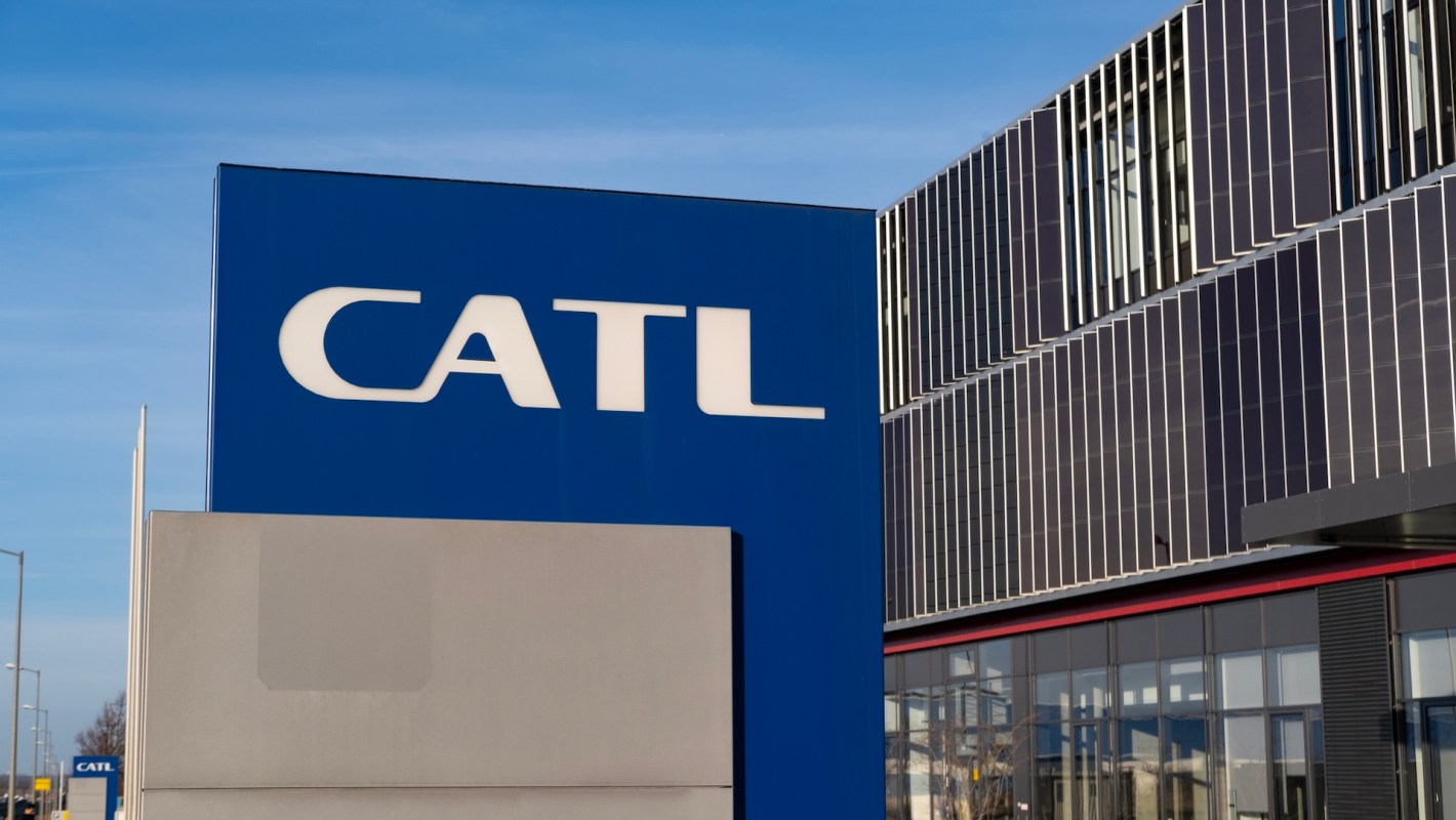 A close-up of a blue sign displaying the CATL logo on a modern building.
