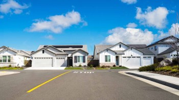 Single family homes on a sunny day in California. One has solar.