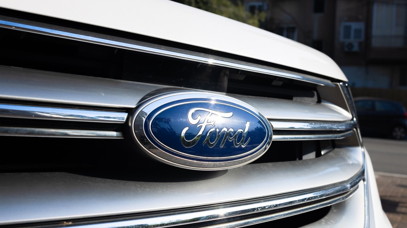 Close-up of a Ford logo on the front grille of a vehicle.