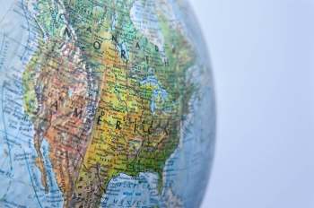 A close-up of a globe highlighting North America with detailed geographical labels.