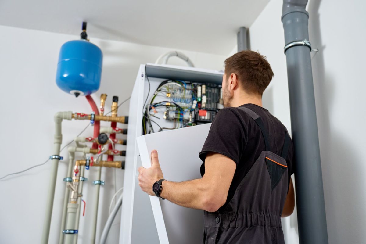 Technician looking at a heat pump water heater.